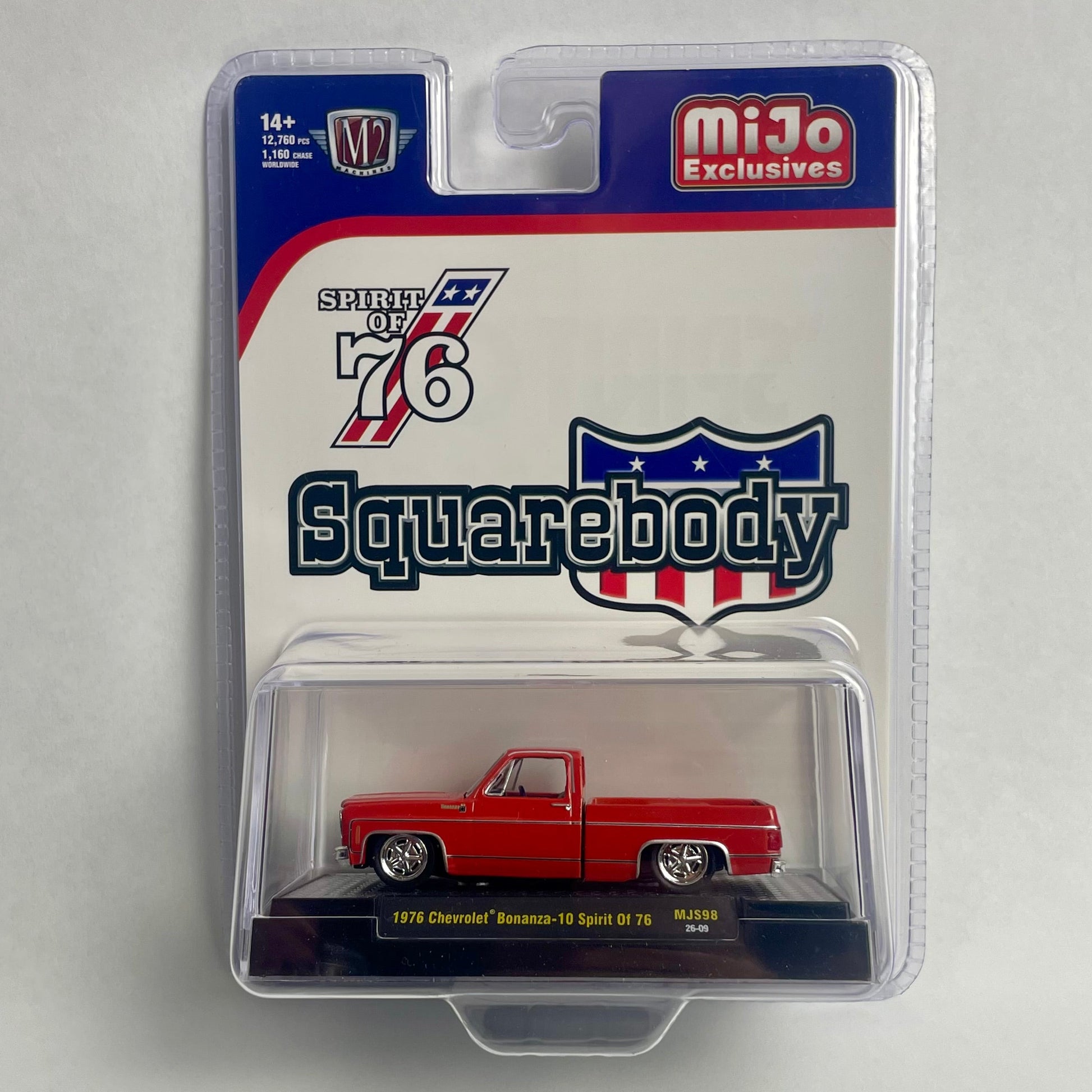 A packaged die-cast model car in a clear blister pack on a light gray background. The product is a red 1976 Chevrolet pickup truck by Squarebody, with the packaging showing the Squarebody logo, MiJo Exclusives branding, and a '76 emblem.
