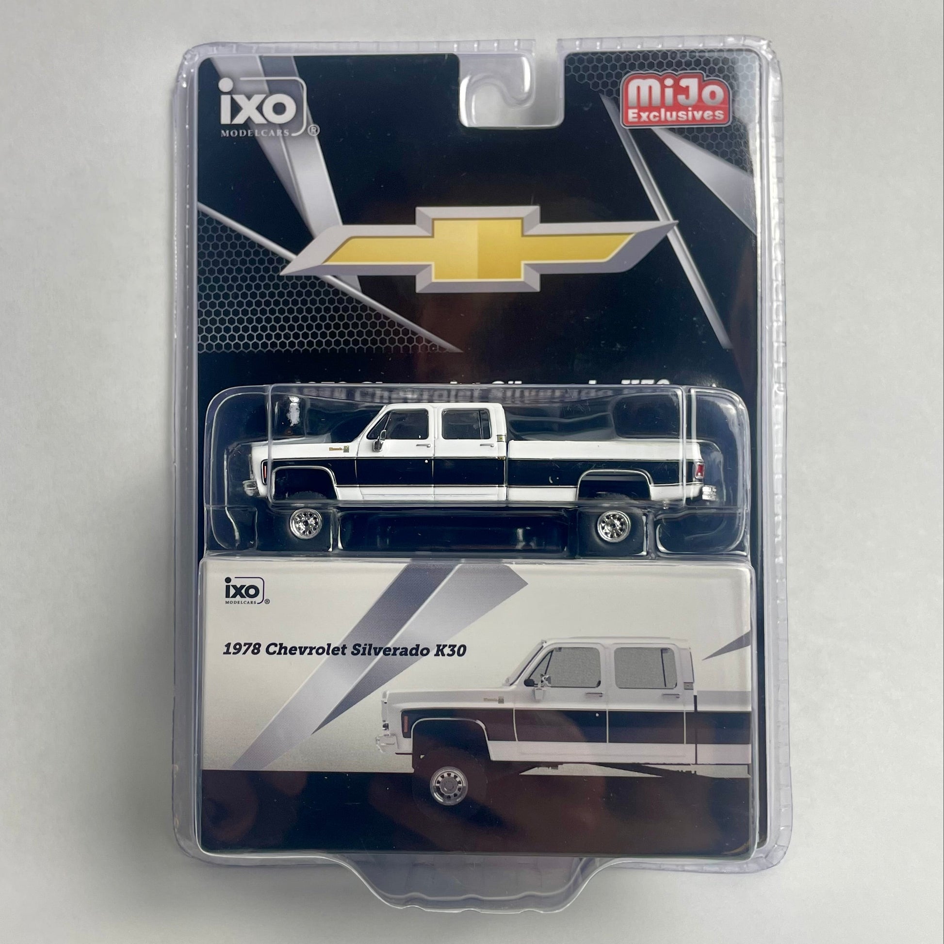 A packaged miniature die-cast model of a 1978 Chevrolet Silverado R30 pickup truck, shown in its original blister pack with a black and white cardback featuring the Chevrolet bowtie logo and an Ixo brand mark.