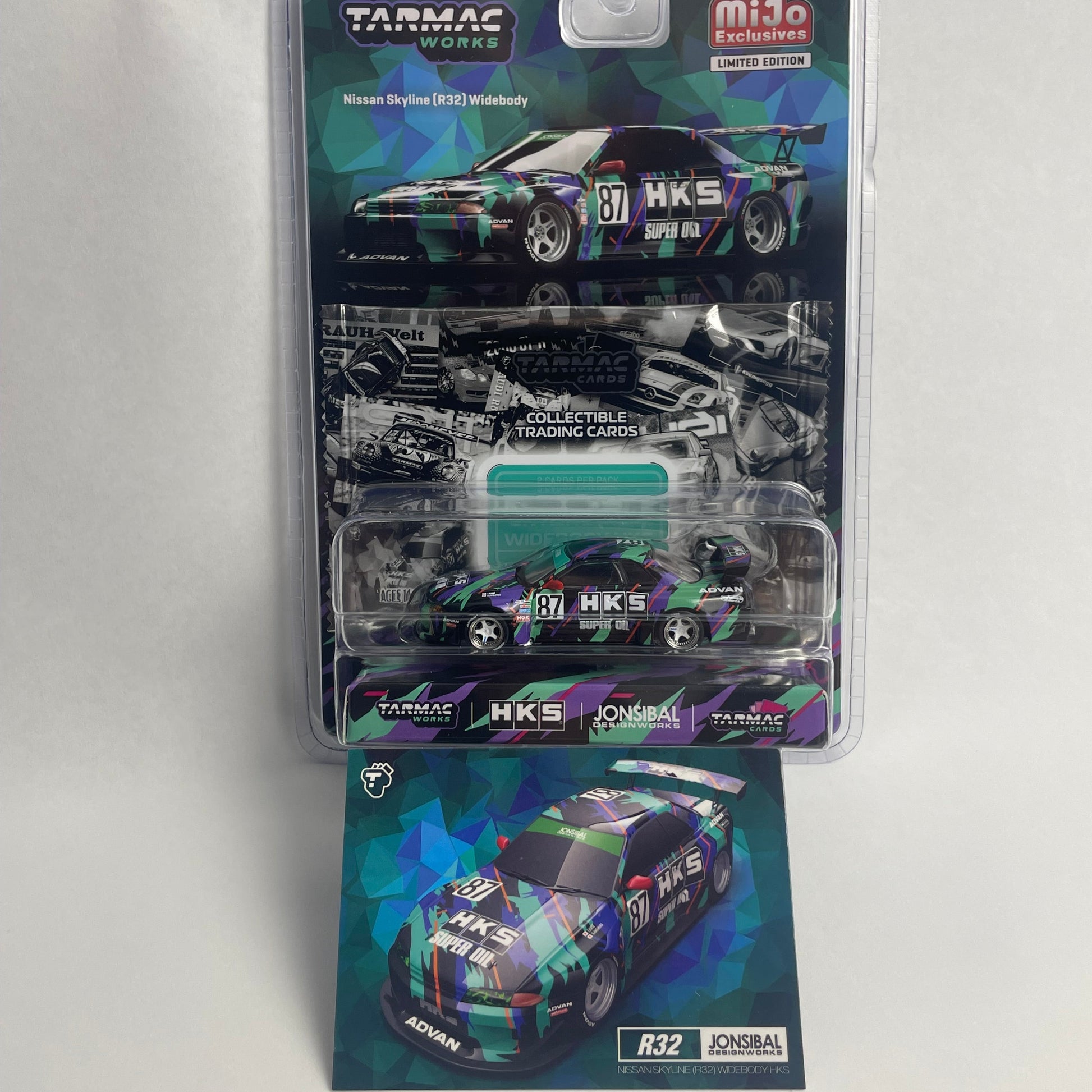 Tarmac Works Mijo Exclusive 1:64 scale diecast model car, GTR R32, in its original blister pack with an additional display card in front, on a neutral gray background.